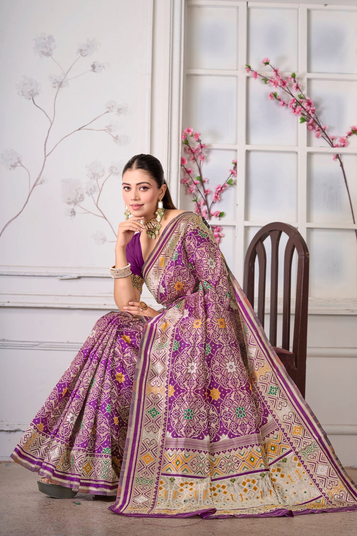 A wine Patola saree, seated drape