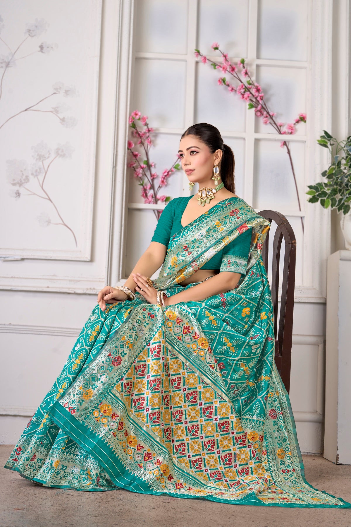 A turquoise Patola saree in sea green silk