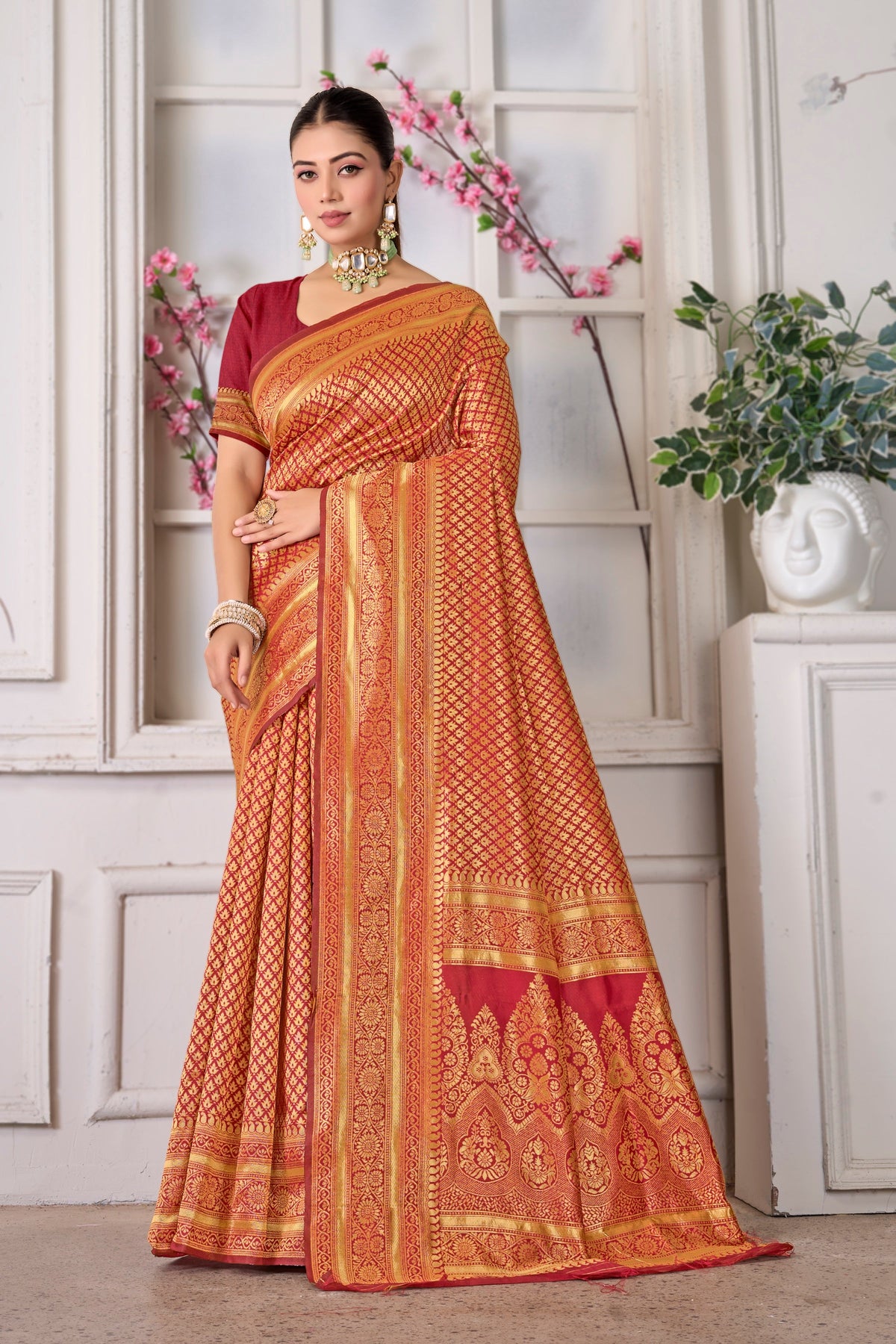 A maroon and rust silk Banarasi saree with gold zari