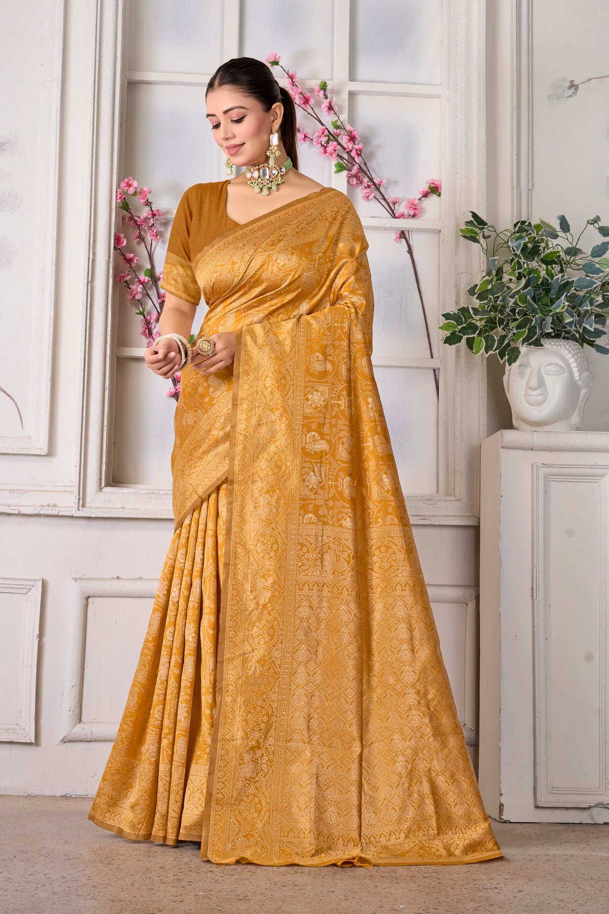 A mustard silk Banarasi saree with tone-on-tone zari