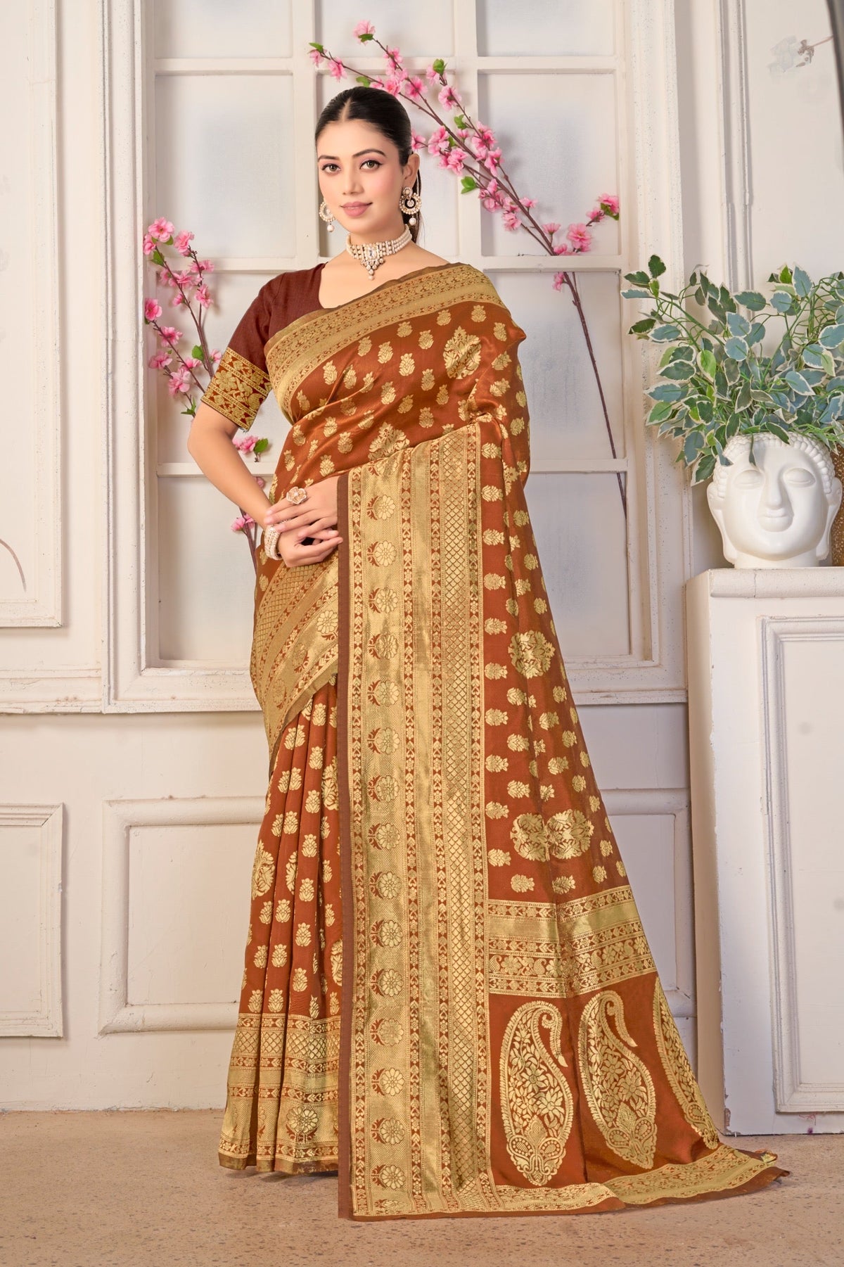 A brown silk Banarasi saree with gold paisley pallu
